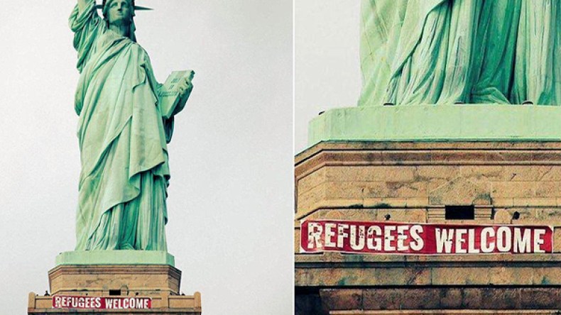 تعليق شعار “مرحباً باللاجئين” على تمثال الحرية في أمريكا