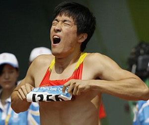 China stunned as superstar hurdler Liu Xiang limps out of the Olympics … shattering the hopes of 1.3 billion people