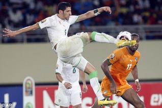 Algerian defender Rafik Halliche talks to Echourok