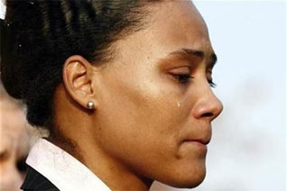 Disgraced sprinter Jones reports to prison
