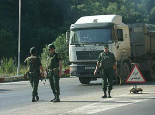 A terrorist surrenders, as security forces dismantle a terrorist back-up cell east of Algiers