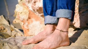 شباب يتزين بسلاسل ذهبية في الأرجل