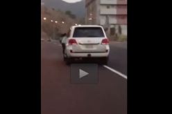 بالفيديو  متهور يقود سيارته وابنته معلقة على الباب مخاطراً بحياتها