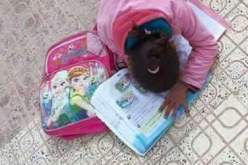 صور طفلة تقوم بواجبها المدرسي على حافة الرصيف تشعل الفايسبوك