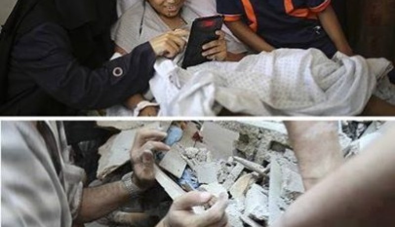صورة اليوم: طفل فلسطيني يشاهد صورته أثناء انتشاله من تحت الانقاذ