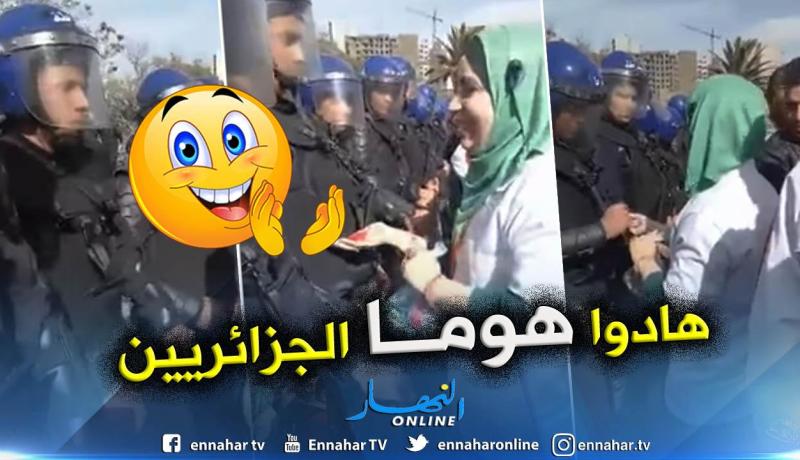 شاهد.. شابة توزع قطع الحلوى على رجال الشرطة خلال مسيرات الجمعة بوهران